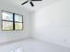 Bright bedroom with high ceilings, fan, light fixtures and marble flooring at 16760 Acapulco Rd, Punta Gorda, FL 33955
