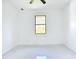 Bedroom features a ceiling fan and exterior view from the window at 16760 Acapulco Rd, Punta Gorda, FL 33955