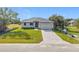Beautiful new home with a dark metal roof, brick paved driveway, and a manicured lawn at 16760 Acapulco Rd, Punta Gorda, FL 33955