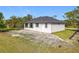 Exterior view of home highlighting architectural style, metal roof, and well-maintained landscaping at 16760 Acapulco Rd, Punta Gorda, FL 33955