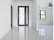 Bright foyer with large entry door, high ceilings and glossy marble flooring at 16760 Acapulco Rd, Punta Gorda, FL 33955
