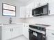 Modern kitchen featuring stainless steel appliances, marble countertops, and sleek black hardware at 16760 Acapulco Rd, Punta Gorda, FL 33955