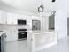 Modern kitchen featuring white cabinets, stainless steel appliances, and an island at 16760 Acapulco Rd, Punta Gorda, FL 33955