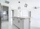Bright kitchen featuring stainless steel refrigerator and a hallway leading to another part of the house at 16760 Acapulco Rd, Punta Gorda, FL 33955