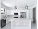 Open kitchen with white cabinets, stainless steel appliances, and a bright island at 16760 Acapulco Rd, Punta Gorda, FL 33955