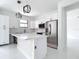 Bright kitchen featuring a modern island, stainless steel appliances, and white cabinetry at 16760 Acapulco Rd, Punta Gorda, FL 33955