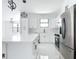 Bright kitchen featuring stainless steel appliances and white cabinets and a view of the living room at 16760 Acapulco Rd, Punta Gorda, FL 33955