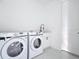 Clean, all white laundry room with sink, counter, and Samsung washer and dryer at 16760 Acapulco Rd, Punta Gorda, FL 33955