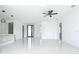 Open-concept living area with modern ceiling fan, tile floors and natural light throughout at 16760 Acapulco Rd, Punta Gorda, FL 33955