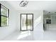 Bright living room features a view of an outdoor patio and open floor plan at 16760 Acapulco Rd, Punta Gorda, FL 33955
