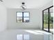Bright living room with black framed sliding glass doors and white marble flooring throughout at 16760 Acapulco Rd, Punta Gorda, FL 33955