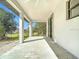 Spacious covered patio with ceiling fan and large sliding glass doors for seamless indoor-outdoor living at 16760 Acapulco Rd, Punta Gorda, FL 33955