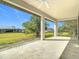 Covered patio area with large open space and a view of the backyard and surrounding trees at 16760 Acapulco Rd, Punta Gorda, FL 33955