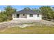 Aerial view of the rear exterior showing a covered patio and ample yard space at 16760 Acapulco Rd, Punta Gorda, FL 33955