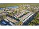 Aerial view of waterfront community with pool, tennis, and pickleball courts at 275 114Th N Ave # 2, St Petersburg, FL 33716