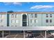 Light teal building with parking and landscaping at 275 114Th N Ave # 2, St Petersburg, FL 33716