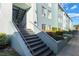 Exterior of a light teal building with stairs and landscaping at 275 114Th N Ave # 2, St Petersburg, FL 33716
