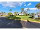 Community building with palm trees and pool hours sign at 275 114Th N Ave # 2, St Petersburg, FL 33716