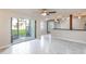 Living room with tile floor, sliding glass doors, and ceiling fan at 275 114Th N Ave # 2, St Petersburg, FL 33716