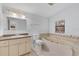 Bathroom boasts a jetted tub, granite vanity, and tiled shower at 4135 Bell Ave, Sarasota, FL 34231