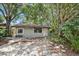 Ranch style home with carport, mature landscaping, and a fenced yard at 4135 Bell Ave, Sarasota, FL 34231