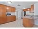 Modern kitchen with wood cabinets, stainless steel appliances, and tile floors at 4135 Bell Ave, Sarasota, FL 34231