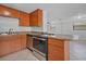 Modern kitchen with stainless steel appliances and wood cabinets at 4135 Bell Ave, Sarasota, FL 34231