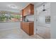 Kitchen features wood cabinets, tile floors and a view to backyard at 4135 Bell Ave, Sarasota, FL 34231