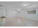 Spacious living area with tile floors and neutral walls at 4135 Bell Ave, Sarasota, FL 34231