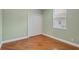 Simple bedroom with light green walls, hardwood floors, and a double-door closet at 2454 Yalta Ter, North Port, FL 34286