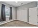 Bright bedroom featuring gray walls, carpet flooring, and ample closet space at 2454 Yalta Ter, North Port, FL 34286