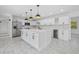 Modern kitchen with island, white cabinets, and marble countertops at 8144 Trionfo Ave, North Port, FL 34287