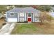 Two-story house, gray siding, red door, and driveway at 7319 Lagoon Rd, Spring Hill, FL 34606