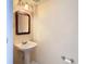Small bathroom with pedestal sink and simple decor at 7319 Lagoon Rd, Spring Hill, FL 34606