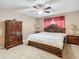 Main bedroom with large bed, wood dresser and ceiling fan at 7319 Lagoon Rd, Spring Hill, FL 34606