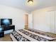 Spacious bedroom with a TV and double doors at 7319 Lagoon Rd, Spring Hill, FL 34606
