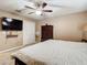 Main bedroom with large bed, double doors, and ceiling fan at 7319 Lagoon Rd, Spring Hill, FL 34606
