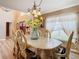 Bright dining room, featuring a large table, chandelier, and sunflowers at 7319 Lagoon Rd, Spring Hill, FL 34606