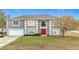 Two-story house with gray siding, red door, and attached garage at 7319 Lagoon Rd, Spring Hill, FL 34606