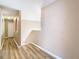 Upstairs hallway with neutral walls and wood-look flooring at 7319 Lagoon Rd, Spring Hill, FL 34606