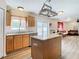 Kitchen features wood cabinets, granite countertops and an island open to the living room at 7319 Lagoon Rd, Spring Hill, FL 34606
