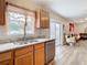 Kitchen with granite countertops, stainless steel sink, and view into living room at 7319 Lagoon Rd, Spring Hill, FL 34606