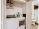 Laundry room with washer, dryer, and storage shelving at 7319 Lagoon Rd, Spring Hill, FL 34606