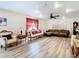 Spacious living room with hardwood floors, sectional sofa, and large artwork at 7319 Lagoon Rd, Spring Hill, FL 34606