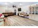 Living room with hardwood floors, sectional sofa, and a large TV at 7319 Lagoon Rd, Spring Hill, FL 34606
