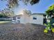 Back of house, showcasing a light-colored exterior and a large yard at 6108 Whiteway Dr, Temple Terrace, FL 33617