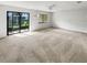 Bright living room featuring carpet and sliding glass doors at 2364 Hanover Dr, Dunedin, FL 34698
