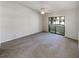 Spacious carpeted bedroom with sliding doors to balcony at 2364 Hanover Dr, Dunedin, FL 34698