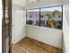 Screened porch with wood flooring and view at 2364 Hanover Dr, Dunedin, FL 34698