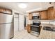 Updated kitchen with stainless steel appliances and light wood cabinets at 4404 Terry Loop, New Port Richey, FL 34652